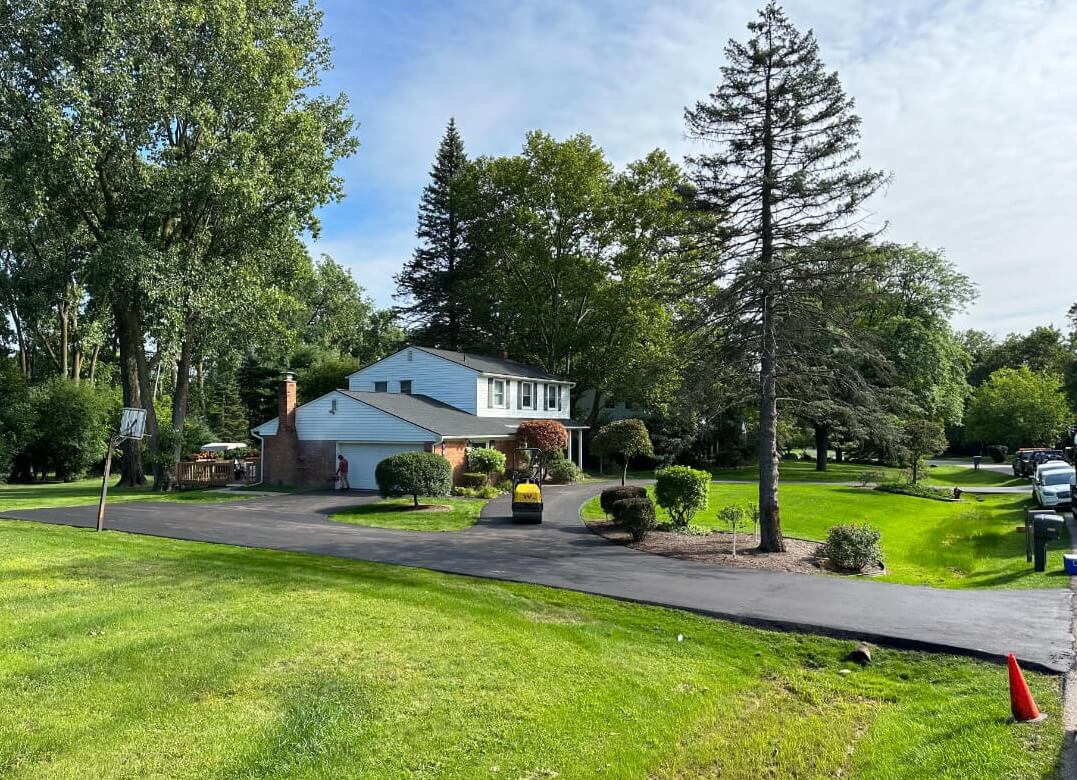 Asphalt driveway installation in progress at a home in Metro Detroit